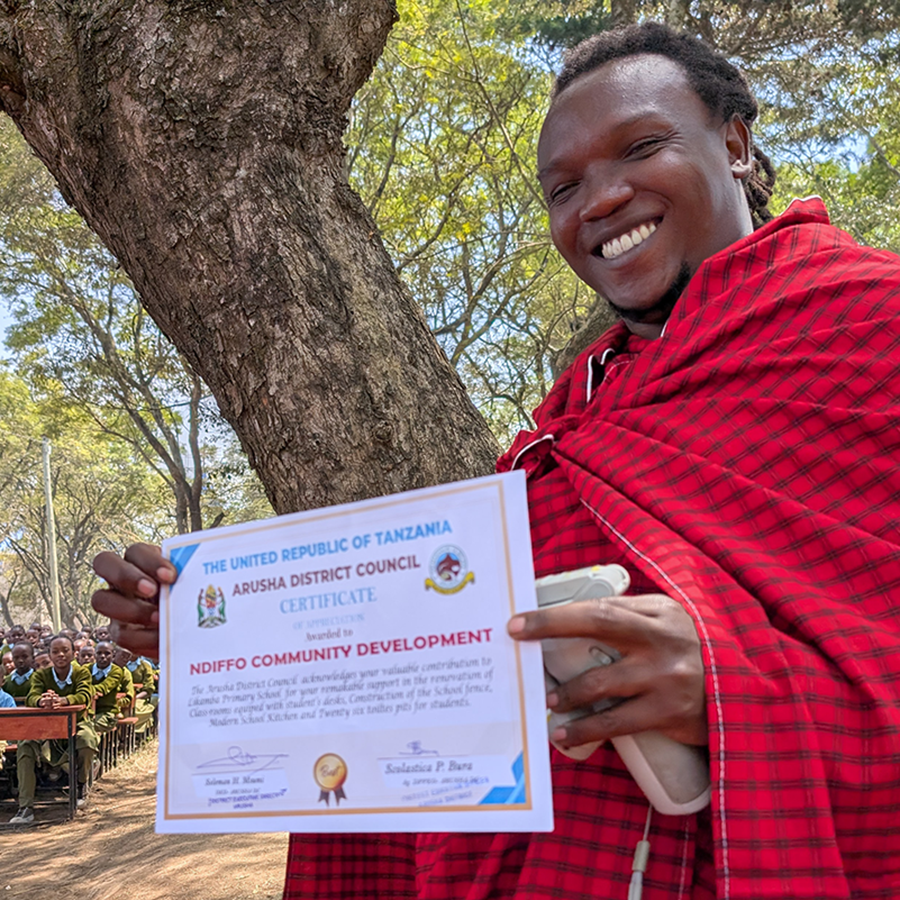 Steven Ngowi holding a community development certificate