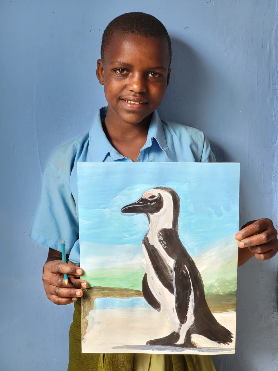 Student holding Penguin artwork