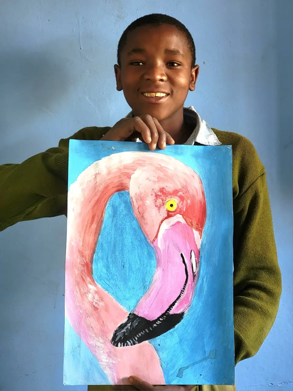 Abel Wilson holding his original flamingo painting
