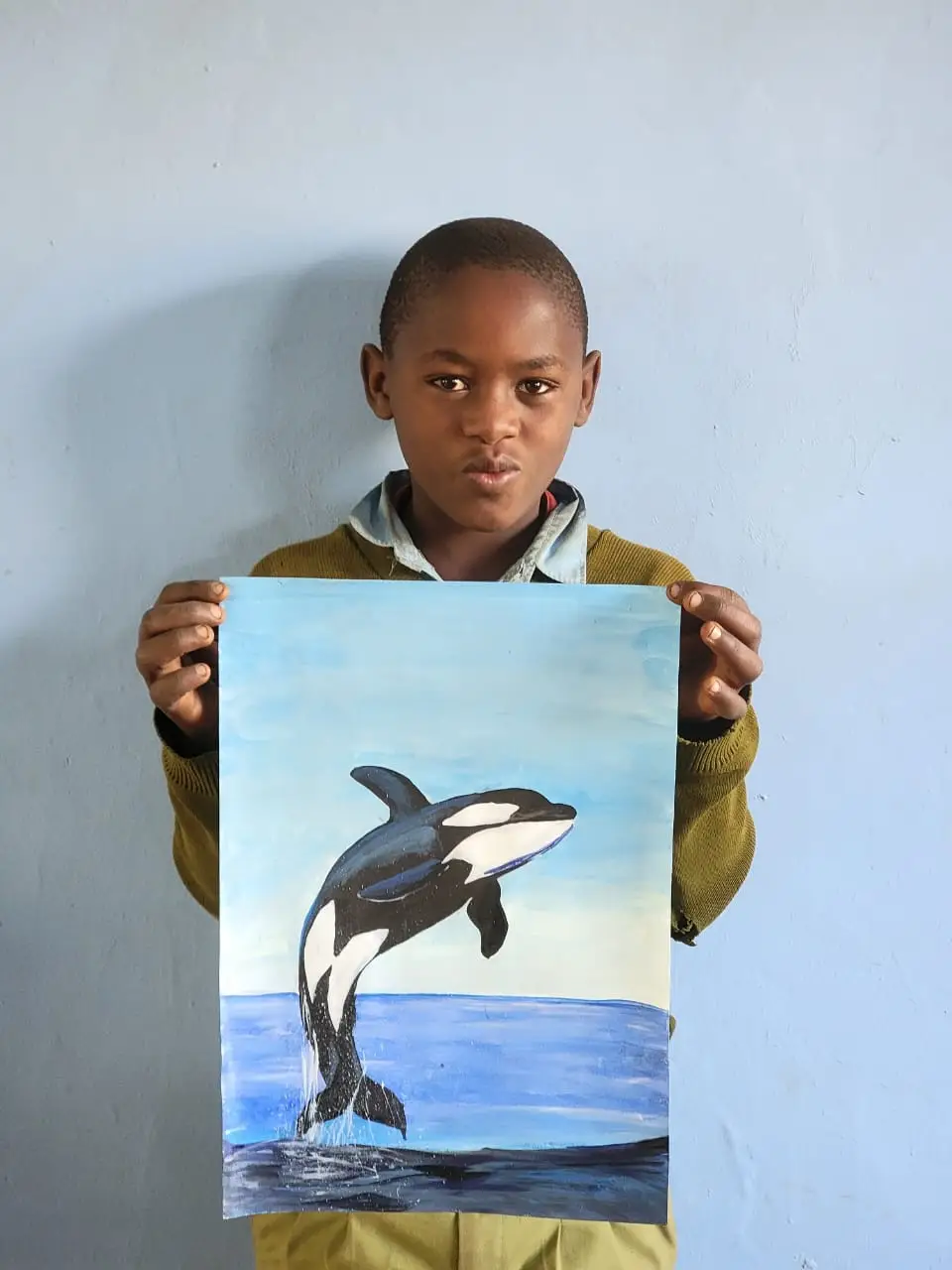 Amosi Robert holding his original orca painting