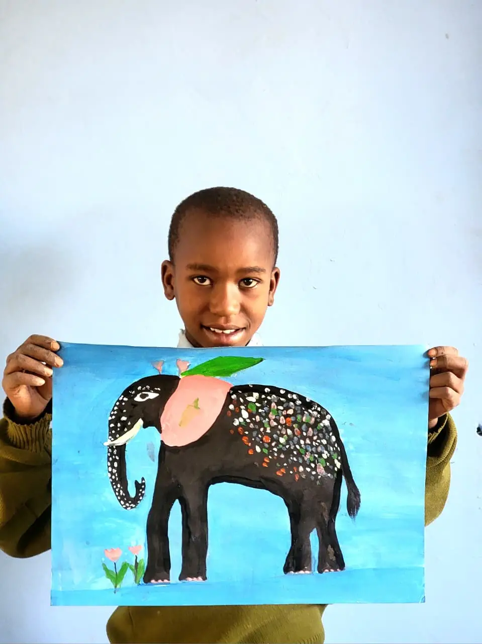 Angelight Samwel holding her original elephant painting