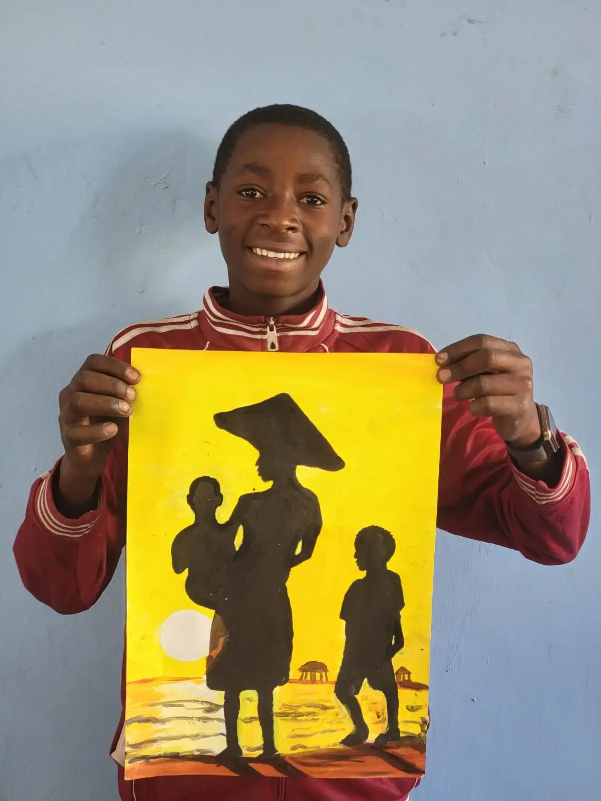 Daniel Lengoma holding his original painting
