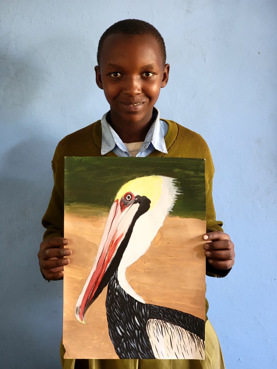 Paulina Joeli holding her original pelican painting